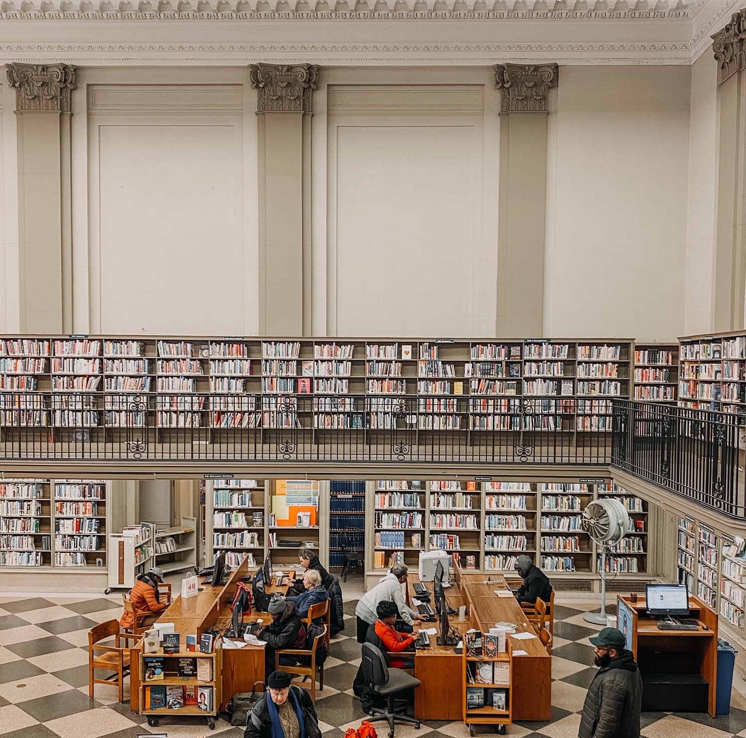 bookshelves and people in Free Library of Philadelphia.