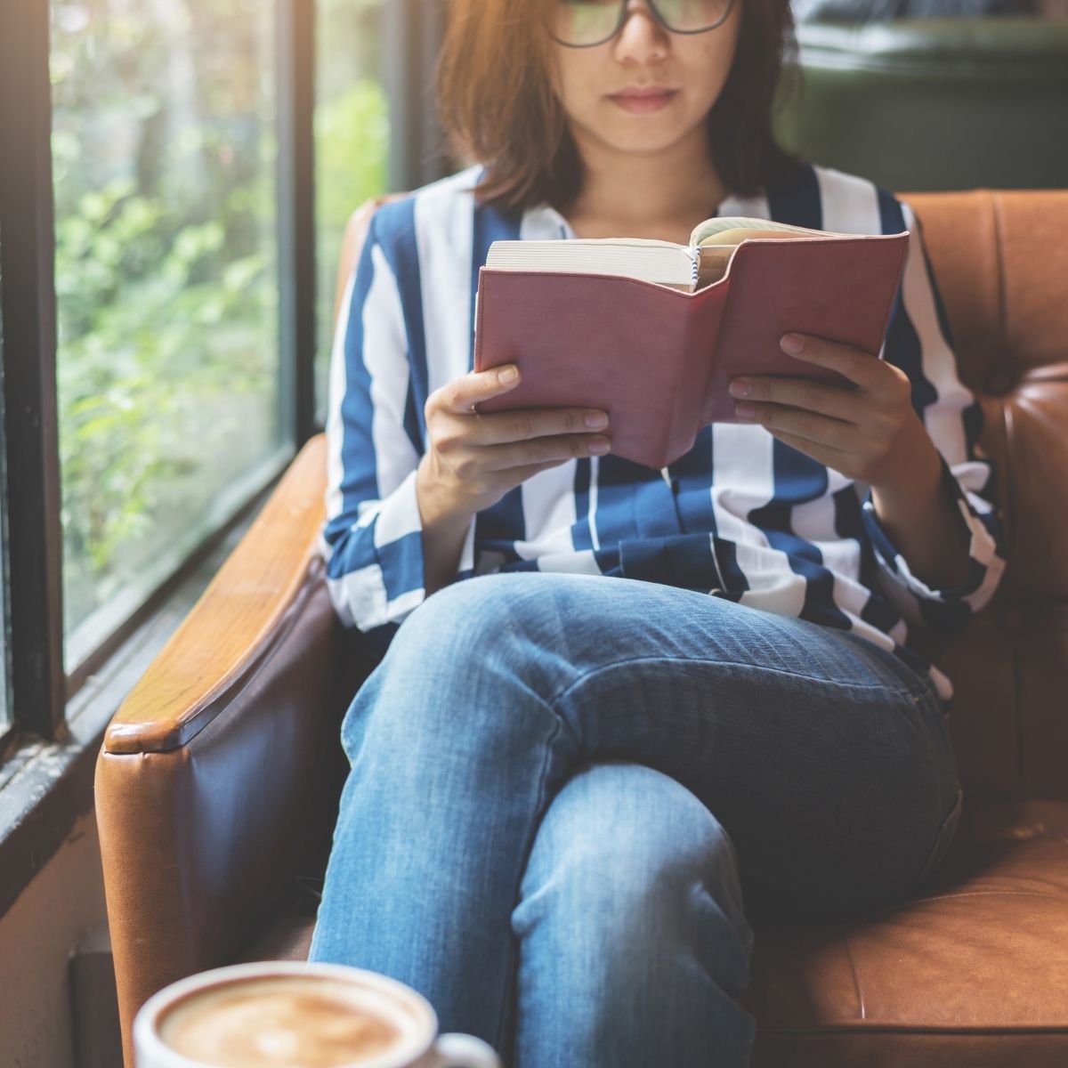 asian woman reading a book.