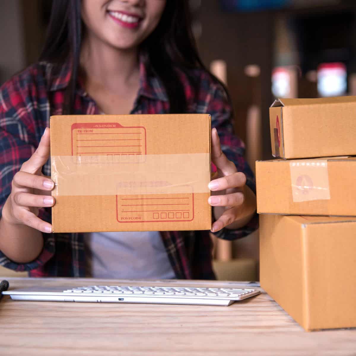 woman holding shipping boxes.