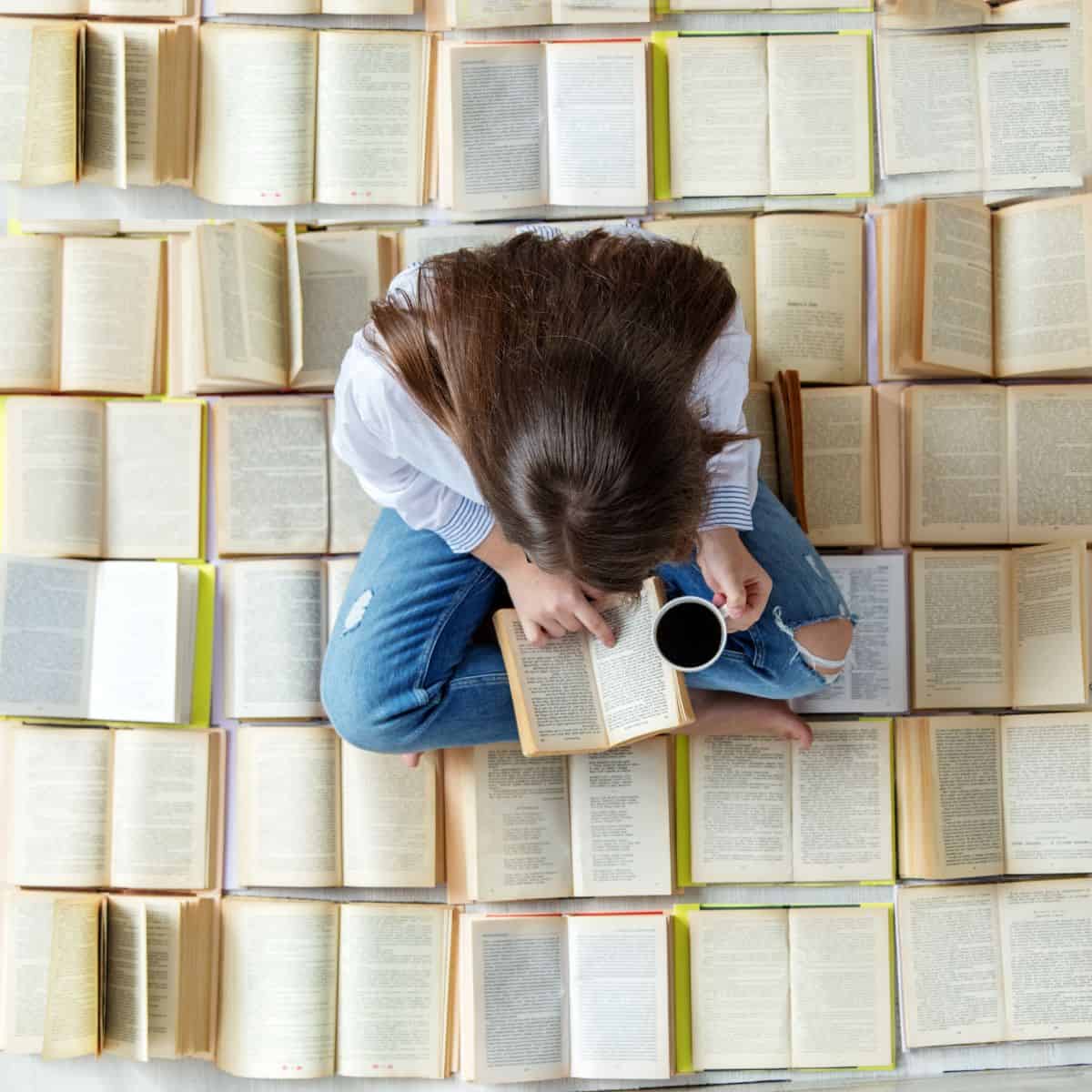 woman reading more than one book.