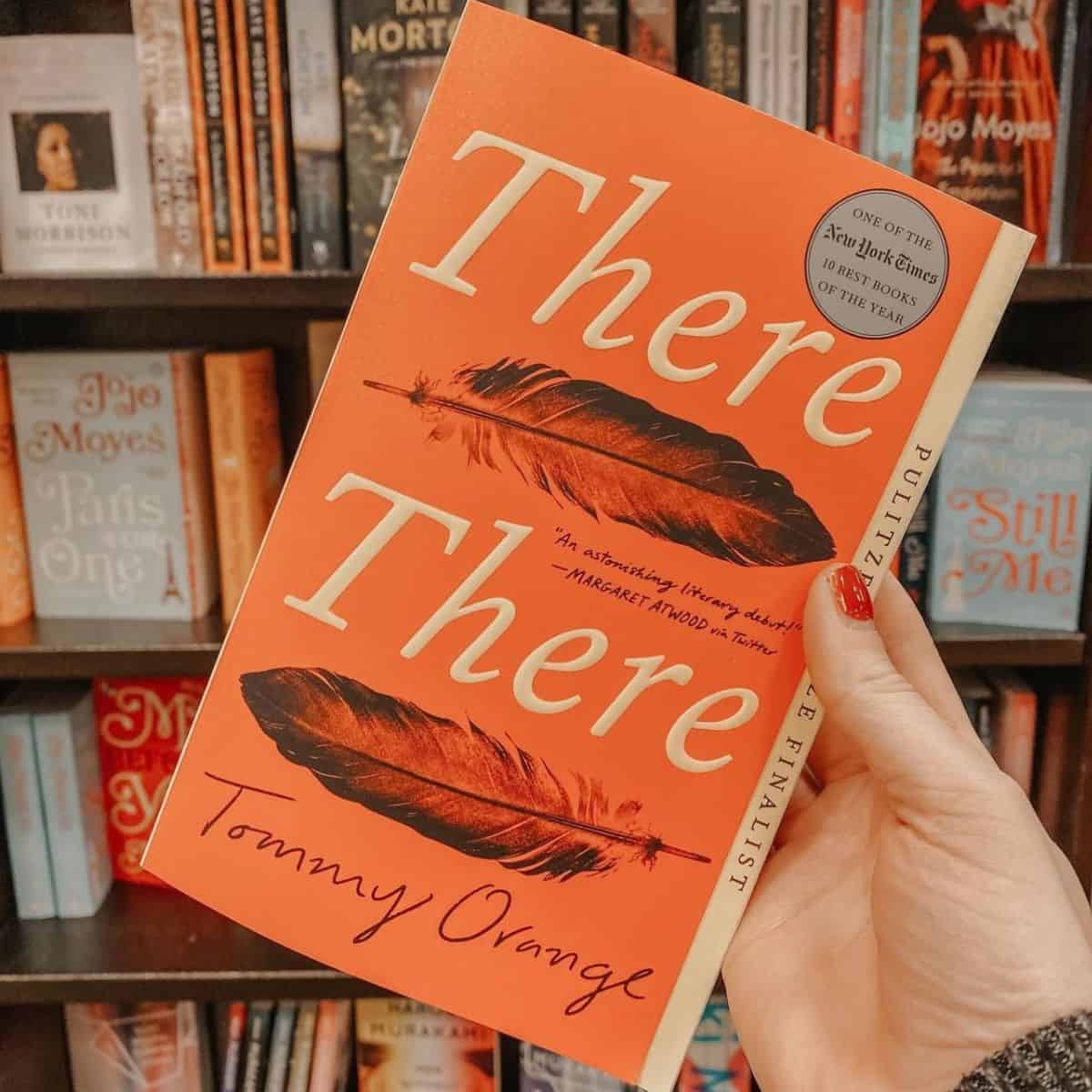 there there by tommy orange in front of bookcase.