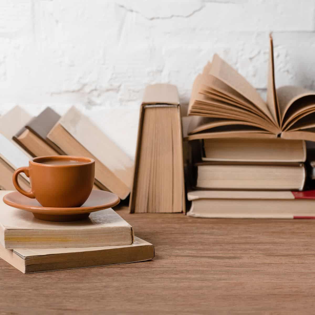 piles of books and a coffee cup.