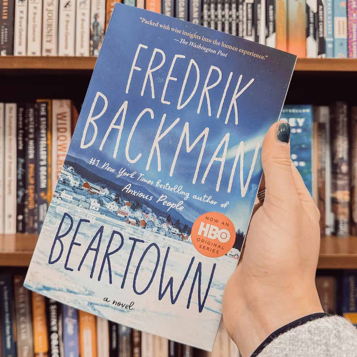 beartown by fredrik backman in front of bookshelves.