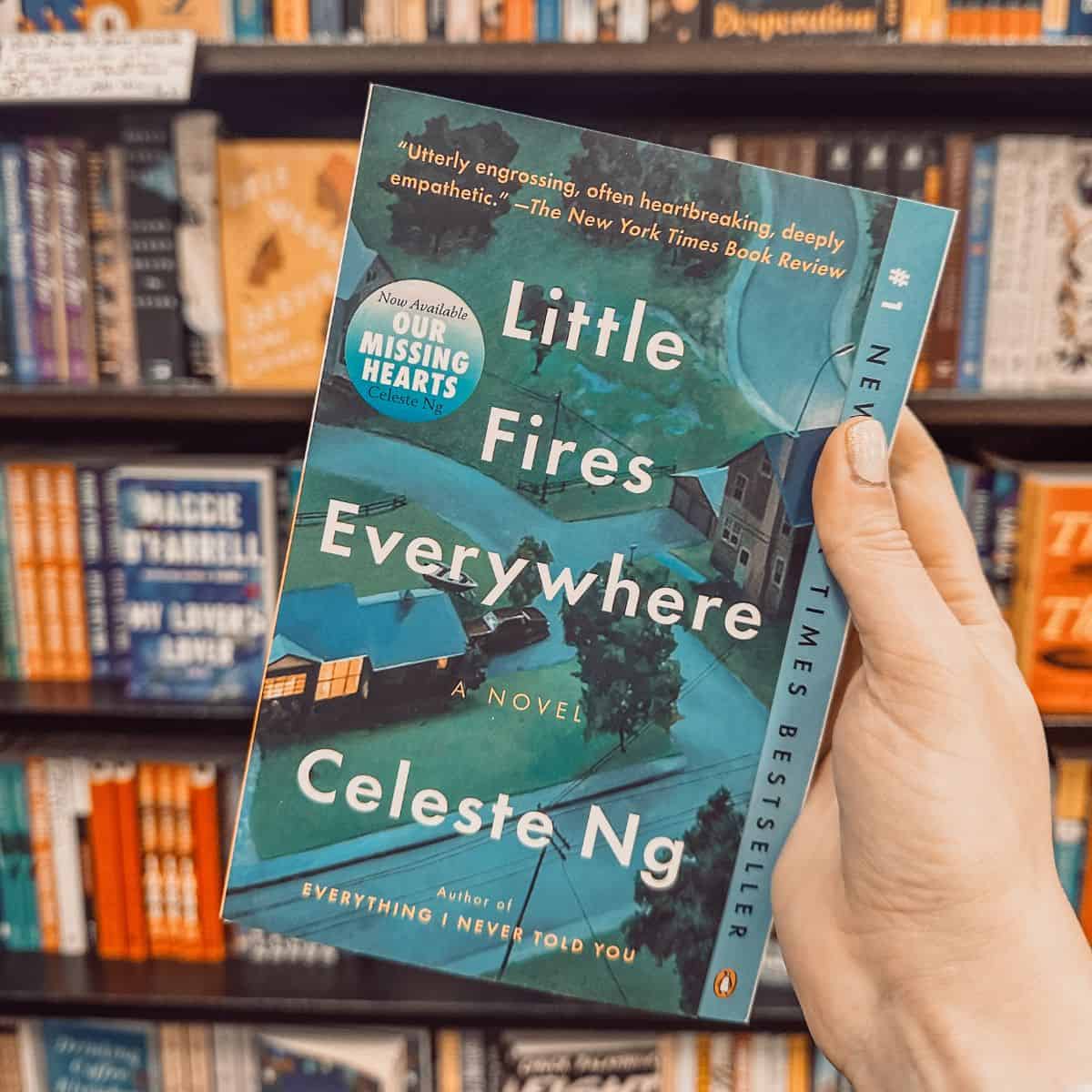 Little fires Everywhere by Celeste ng in front of a bookshelf.