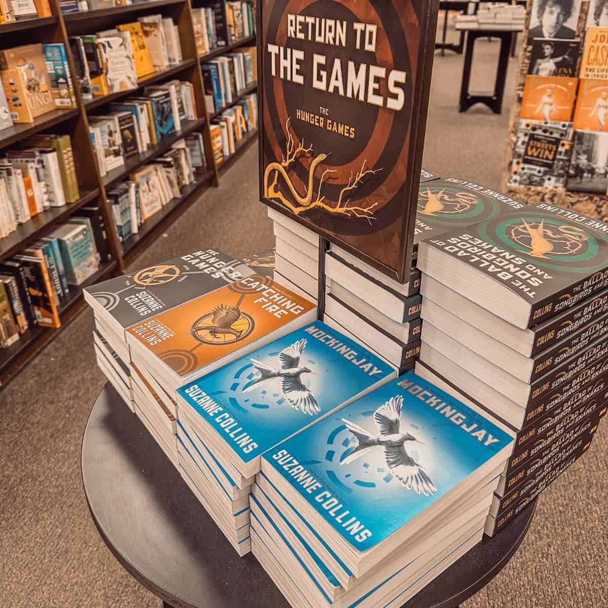 The Hunger Games books by Suzanne Collins on a table in a bookstore.