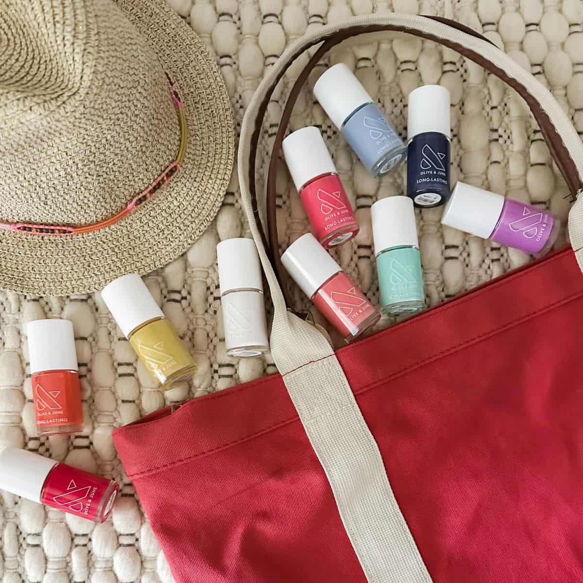 Collection of Beach nail polish colors with a beach bag.