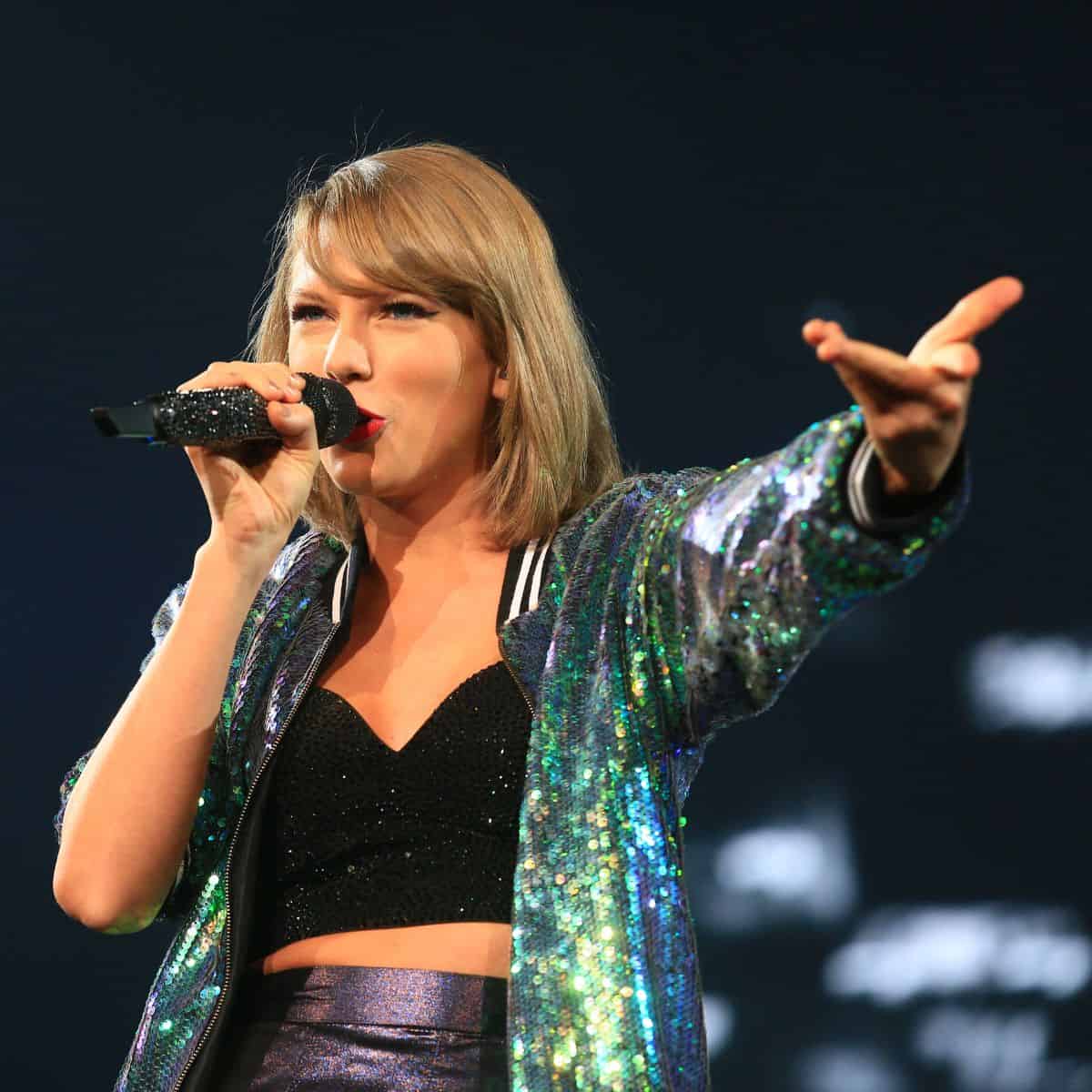 Taylor Swift singing on stage.