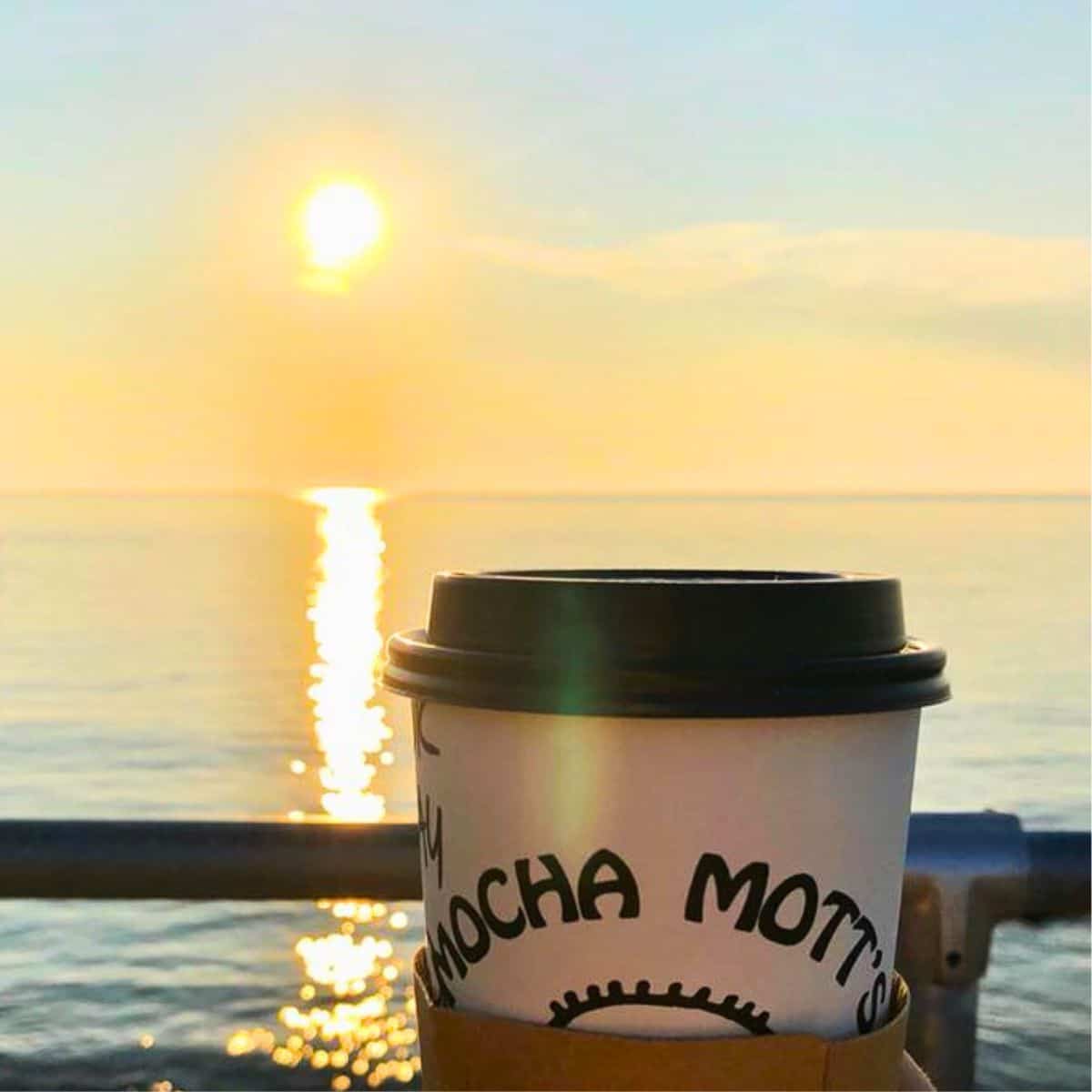 mocha mott's coffee in front of the ocean.