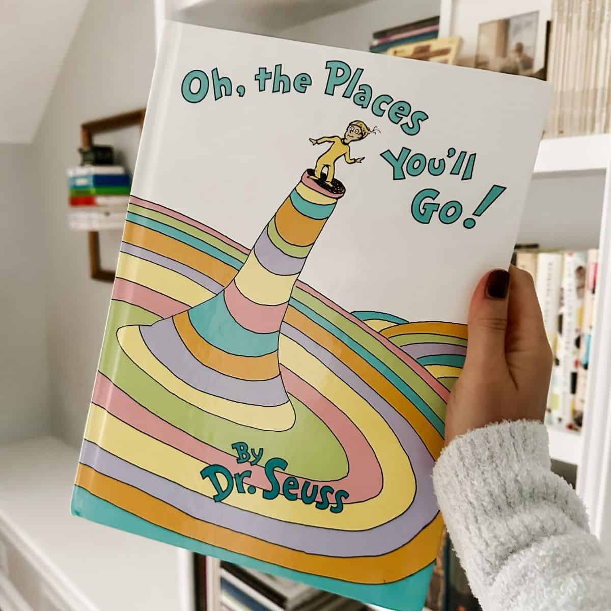 oh the places you'll go by dr. seuss in front of a bookcase.