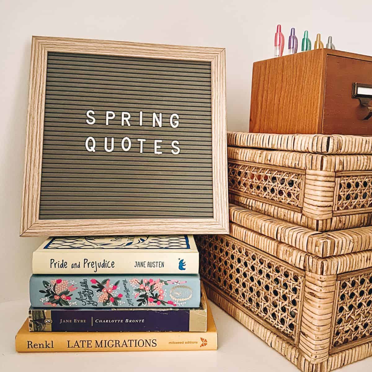 spring quotes on a letter board with a spring bookstack.