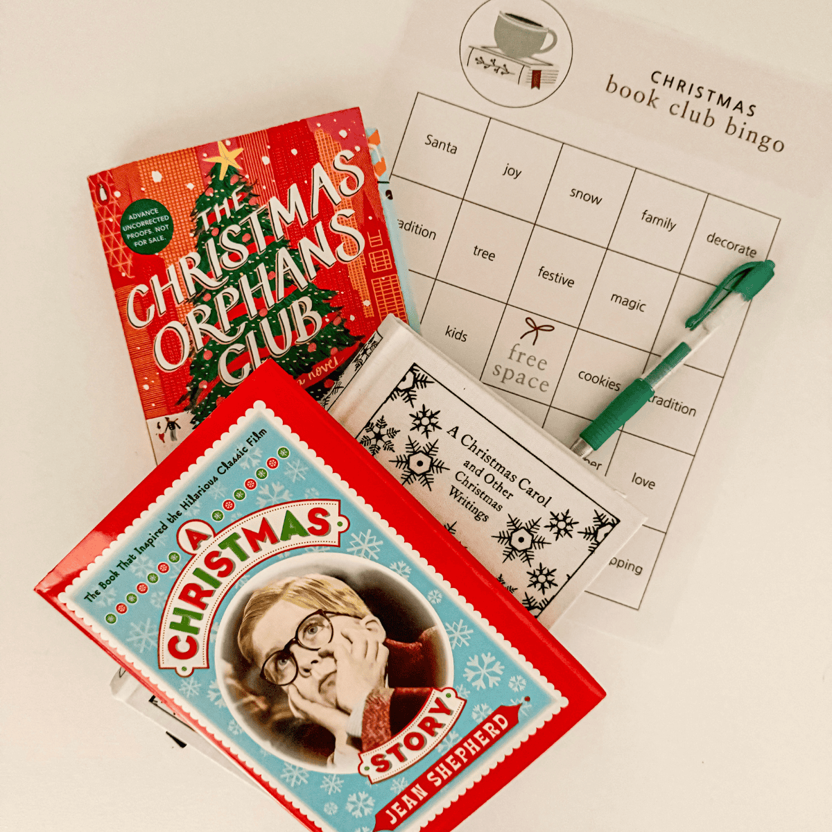 Collection of Christmas Book Club books with Christmas book club Bingo game.